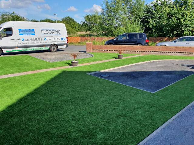 Artificial grass in driveway of house 1